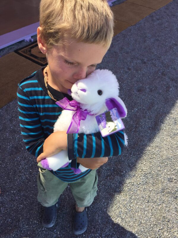 child-holding-lavender-doll